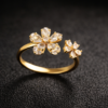 Gold diamond ring on black satin Pavira Blossom Dual Flower Ring