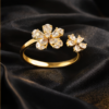Gold diamond ring on black satin3 Pavira Blossom Dual Flower Ring